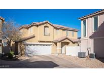 Two-story home featuring a tile roof, stucco exterior, and an attached two-car garage at 9906 Fife Lake Ct, Las Vegas, NV 89148