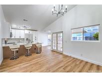 Bright, open kitchen features a breakfast bar with seating and modern white cabinets at 1183 Winnipeg Ct, Henderson, NV 89002