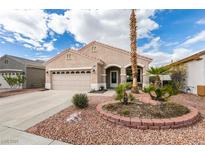 Charming single-story home featuring a two-car garage, landscaped front yard, and a red tile roof at 1808 Eagle Village Ave, Henderson, NV 89012