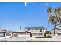 Charming two-story home with a covered parking area, balcony, a small lawn, and desert landscaping at 2834 Natalie Ave, Las Vegas, NV 89121