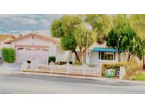 Charming single-story home with mature trees and a well-maintained white picket fence at 3572 Tempe St, Las Vegas, NV 89103