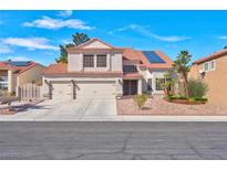 Charming two-story home featuring a terracotta tile roof, solar panels, and a spacious three-car garage at 37 Stone Cress Dr, Henderson, NV 89074