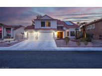 Charming two-story home featuring a three-car garage, desert landscaping, and a red tile roof with solar panels at 37 Stone Cress Dr, Henderson, NV 89074