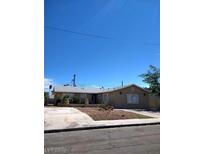 Charming single-story home featuring a well-maintained front yard and a spacious driveway under a clear blue sky at 6225 Factor Ave, Las Vegas, NV 89107