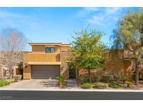 Charming two-story home with a two-car garage, stone accents, and desert landscaping at 80 Pristine Glen St, Las Vegas, NV 89135