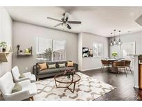 Bright living room featuring a ceiling fan, modern furnishings, and stylish decor at 9580 W Reno Ave # 211, Las Vegas, NV 89148