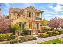 Charming two-story home featuring a stone facade, a small balcony, and a well-manicured front yard at 11298 Merado Peak Dr, Las Vegas, NV 89135