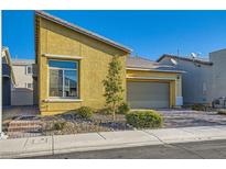 Charming single-story home with a landscaped front yard and a two-car attached garage at 320 San Antonio River St, North Las Vegas, NV 89084