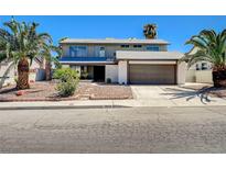 Charming two-story home with mature palm trees and low-maintenance desert landscaping at 3953 E Reno Ave, Las Vegas, NV 89120