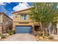 Charming two-story home features a blue garage door and beautifully landscaped front yard at 4512 Moon Hill Rock Ave, North Las Vegas, NV 89084