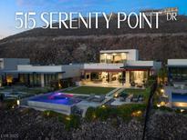 Stunning modern home with a pool, lush landscaping, and a hillside backdrop at 515 Serenity Point Dr, Henderson, NV 89012