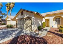 Charming home featuring a well-maintained exterior and a two-car garage at 5448 Cove Point Dr, Las Vegas, NV 89130