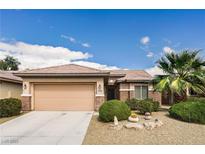 Charming single-story home featuring a well-maintained front yard with desert landscaping and an attached two-car garage at 5944 Saddle Horse Ave, Las Vegas, NV 89122