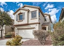 Inviting two-story home featuring a front-facing two-car garage and low maintenance landscaping at 6342 War Emblem Ct, Las Vegas, NV 89141