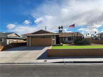 Charming single-story home featuring an attached garage, landscaped yard, and an American flag at 6429 Hill View Ave, Las Vegas, NV 89107