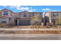 Charming two-story home with a two-car garage and well-manicured front yard with colorful brick pavers at 745 Black Palace St, Henderson, NV 89011