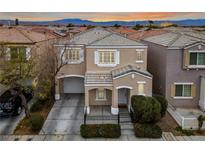 Charming two-story home with a well-manicured lawn and attached garage at 10341 Beautiful Fruit St, Las Vegas, NV 89183