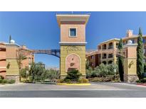 Grand community entrance featuring stone accents, manicured landscaping, and inviting architecture at 15 Via Mantova # 308, Henderson, NV 89011