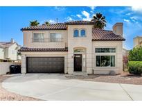 Charming two-story home featuring a tile roof, arched entryway and attached two-car garage at 293 Winter Creek Ct, Henderson, NV 89074