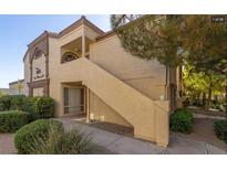 Charming condo with well-manicured landscaping, covered entryway, and private staircase to upper units at 3673 Ian Thomas St # 201, Las Vegas, NV 89129