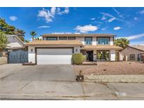 Charming two-story home features a large garage, secure gate, and manicured gravel landscaping at 3916 Green Leaf Dr, Las Vegas, NV 89120