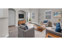 Comfortable living room featuring a stylish sofa, armchairs, and a wooden coffee table at 3975 N Hualapai Way # 235, Las Vegas, NV 89129