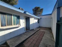 Charming single-story home with a welcoming entrance and white wooden facade, freshly painted and inviting at 4032 Great Plains Way, Las Vegas, NV 89121