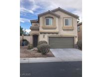 Two-story home with neutral-toned stucco, arched entry, two-car garage, and manicured front landscaping at 405 Center Green Dr, Las Vegas, NV 89148