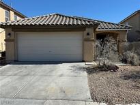 Single Gathering home with a tile roof, two-car garage, and low maintenance landscaping at 4200 English Walnut Ct, Las Vegas, NV 89115