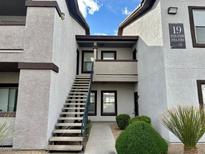 Condo exterior with stairs leading to unit, desert landscaping, and building number at 45 Maleena Mesa St # 1921, Henderson, NV 89074
