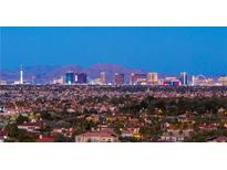 Panoramic view of the Las Vegas skyline at twilight with mountain backdrop at 5020 Spanish Heights Dr, Las Vegas, NV 89148