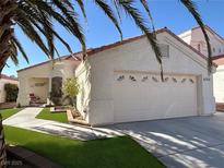 Charming single-story home featuring a two-car garage, terracotta roof and inviting desert landscaping with artificial turf at 6705 Old Newbury Ave, Las Vegas, NV 89108