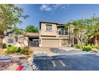 Attractive two-story house featuring a three-car garage, front yard, and beautiful landscaping at 7210 El Malpais St, Las Vegas, NV 89118