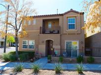Charming two-story home with a balcony, landscaped yard, and inviting curb appeal in a residential neighborhood at 7665 Calico Fields St, Las Vegas, NV 89149