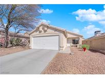Charming single-story home with a two-car garage and low maintenance desert landscaping at 8468 W Gilmore Ave, Las Vegas, NV 89129