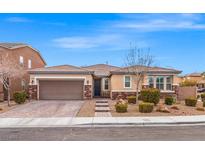 Charming single-story home featuring a well-maintained front yard with desert landscaping and a two-car garage at 8863 Nolene Stream St, Las Vegas, NV 89131