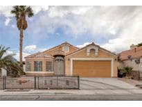 Inviting single-story home with a well-manicured front yard and a two-car garage at 1311 Watercreek Dr, North Las Vegas, NV 89032