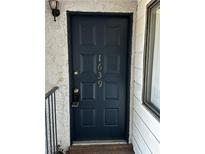 A dark painted front door with the house numbers in a gold paint at 1639 Justin Cir # 1639, Henderson, NV 89011