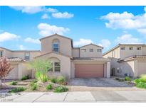 Charming two-story home featuring neutral stucco, brown garage door, and manicured front yard landscaping at 227 Badwater Basin St, Las Vegas, NV 89138