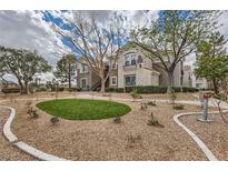 Attractive two-story condo building with landscaped grounds and desert rock at 2325 Windmill Pkwy # 811, Henderson, NV 89074