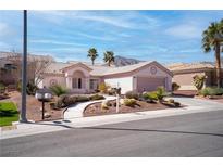 Charming single-story home with desert landscaping, palm trees, and a two-car garage at 3025 Treesdale Dr, Las Vegas, NV 89134