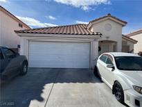 Charming single-story home with a two-car garage, neutral paint, a terracotta tile roof, and low-maintenance landscaping at 3673 Spring Day Ct, Las Vegas, NV 89147