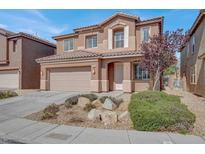 Charming two-story home with a tile roof, arched entryway, and manicured landscaping at 4036 W Bird Man Ln, North Las Vegas, NV 89084