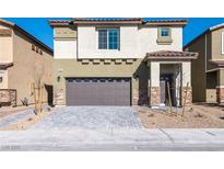 Charming two-story home with a two-car garage and a well-manicured front yard at 480 Silverweed Ave, Henderson, NV 89044