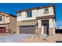 Charming two-story home featuring a two-car garage, stone accents, and a well-maintained front yard at 480 Silverweed Ave, Henderson, NV 89044