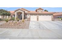 Charming single-story home featuring a desert landscape, tile roof and a 2-car garage with a wide driveway at 5008 Tropical Ridge Ct, Las Vegas, NV 89130