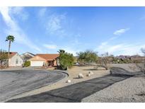 Single story home with a terra cotta roof, desert landscaping and an attached two car garage at 540 Viva Serenade Way, Henderson, NV 89015