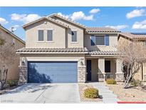 Inviting two-story home featuring a blue garage door, stone accents, and well-maintained landscaping at 5662 Tingley Ave, Las Vegas, NV 89141