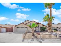 Charming single-Gathering home with a two-car garage, desert landscaping, and a palm tree-lined front yard at 6611 Ellerhurst Dr, Las Vegas, NV 89103
