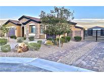Charming single-story home with stone accents, desert landscaping, and a gated driveway at 7143 Nodding Thistle Ct, Las Vegas, NV 89178